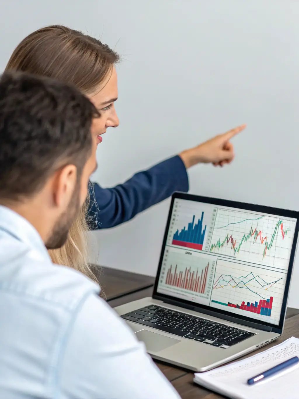 An image of a business coach guiding a client through a business growth strategy session, using visual aids like charts and graphs.
